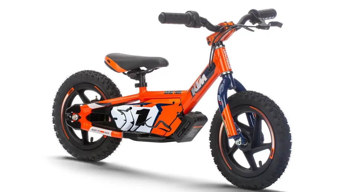 Vue latérale dynamique de la KTM SX-E 1.12 en action sur terrain tout-terrain